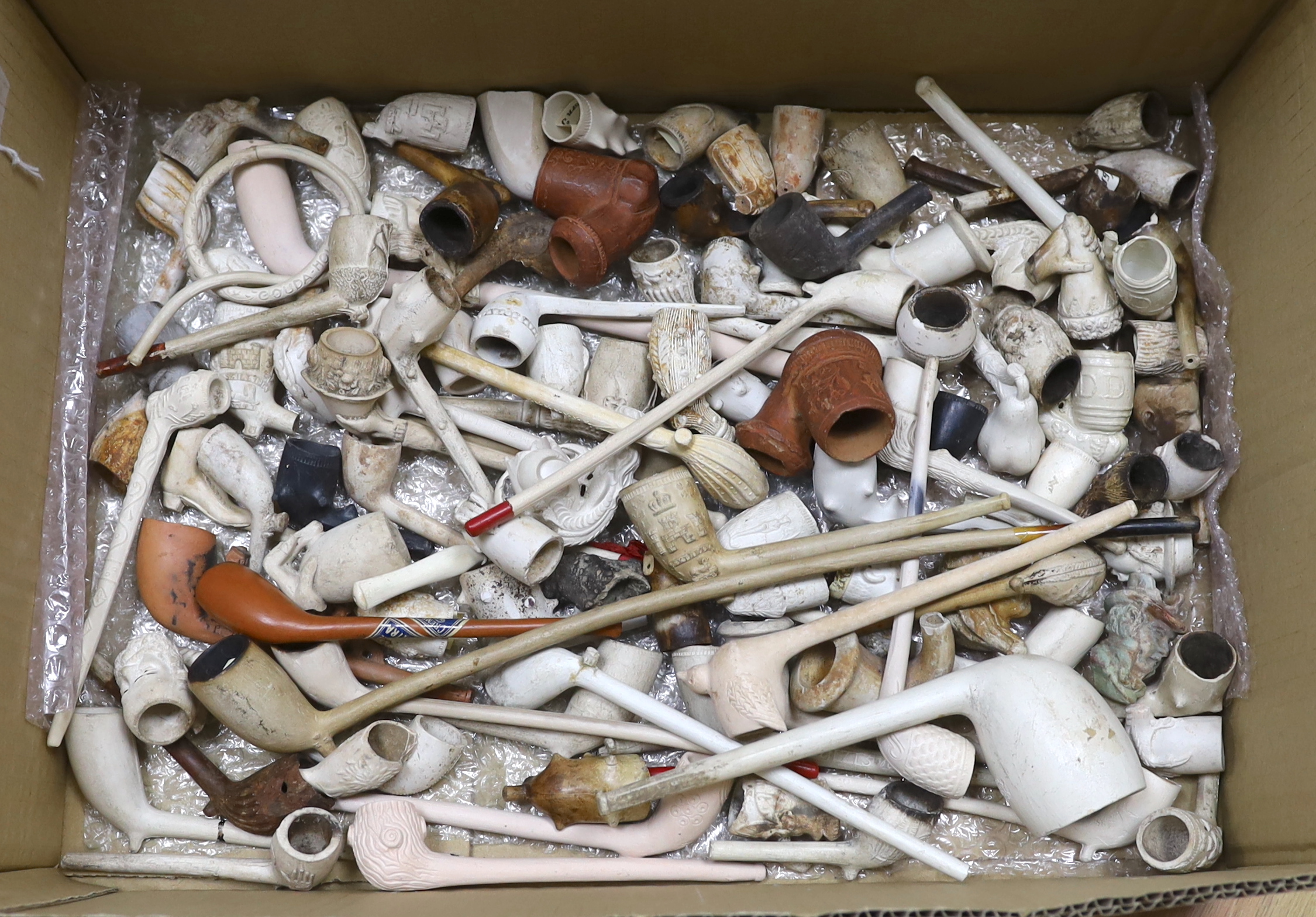 A collection of 19th century decorative clay pipes and parts